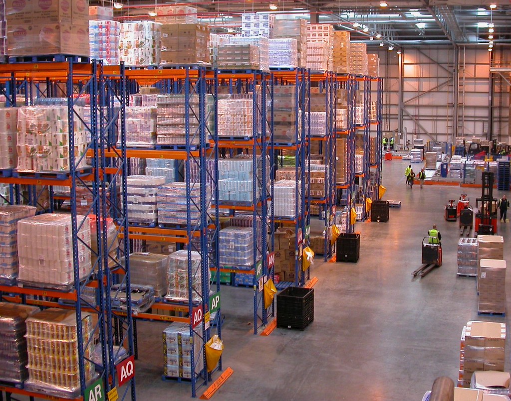 Racked pallets and stock inside a busy distribution warehouse