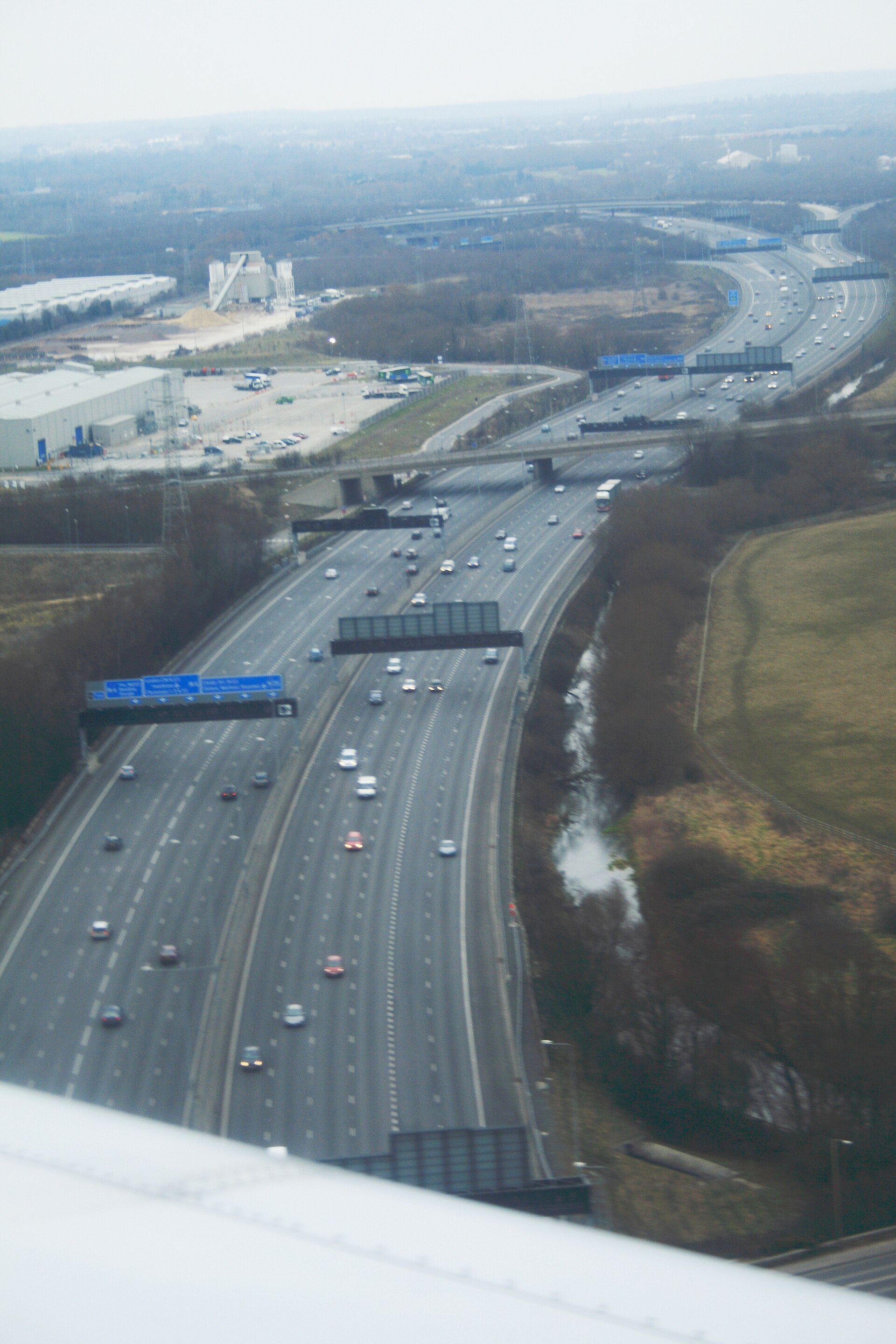 Aerial view of a busy UK motorway network with freight moving between junctions